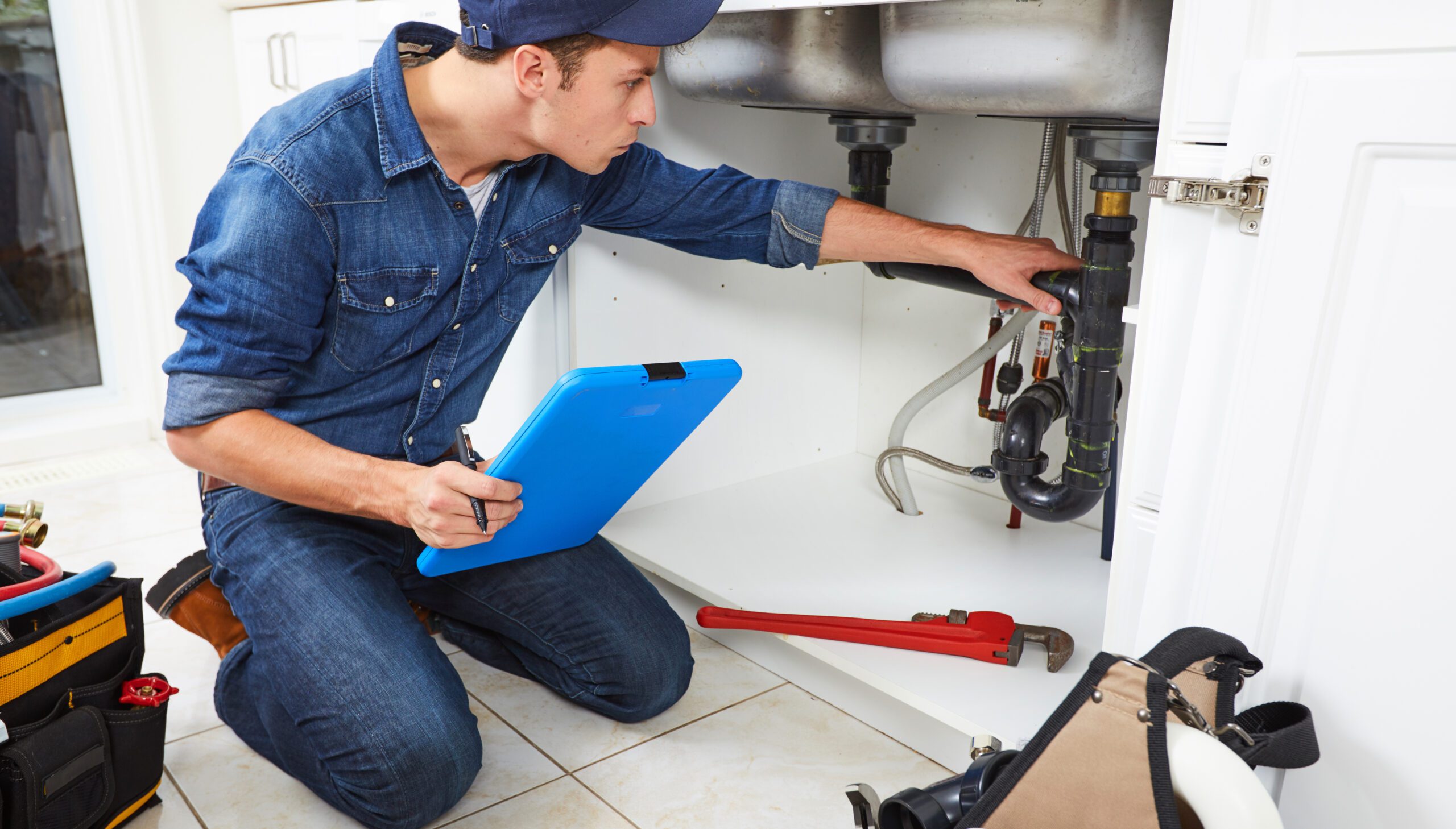 Plumber Checking and Repairing Sink