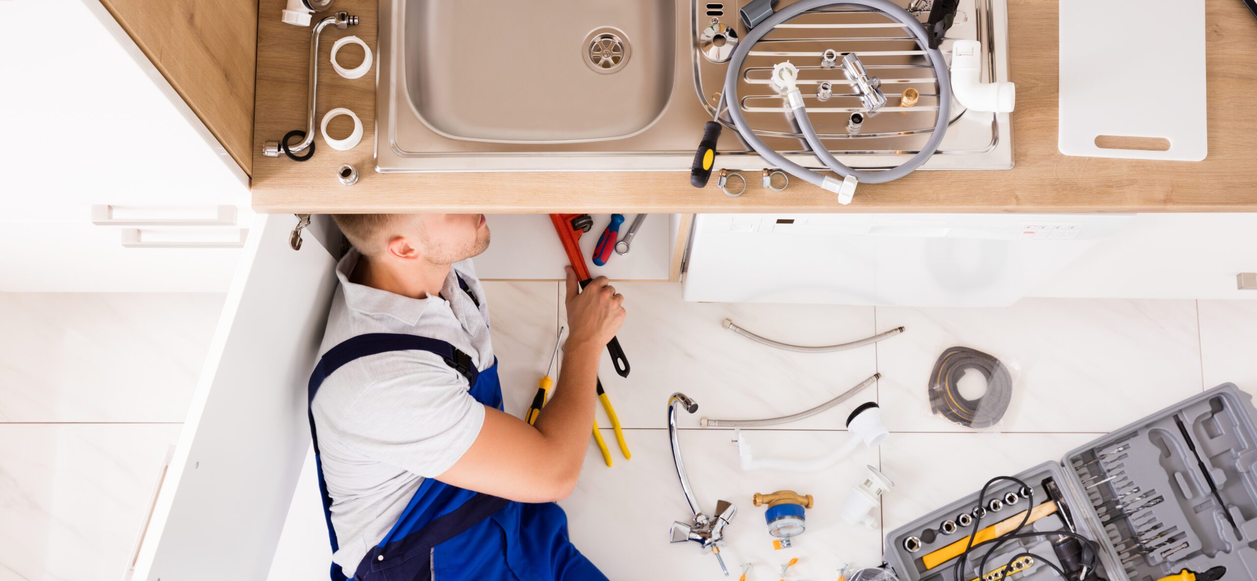 Plumber In Overall Fixing Sink Pipe